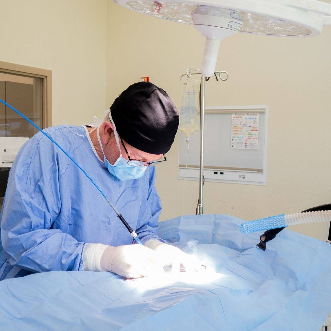 surgeon performing operation on patient